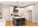 Well-lit kitchen featuring an island with seating and modern pendant lighting at 1208 Thomas Rd, Decatur, GA 30030