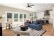 Open-concept living room with hardwood floors, stylish furnishings, and access to outdoor deck at 1208 Thomas Rd, Decatur, GA 30030