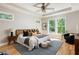 Serene main bedroom with tray ceiling, ceiling fan, multiple windows, and neutral décor at 1208 Thomas Rd, Decatur, GA 30030