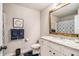 Stylish bathroom featuring a granite countertop, wood-framed mirror, blue towels and modern decor at 263 Osier Dr, Mcdonough, GA 30252