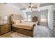 Bedroom with a tray ceiling, neutral color scheme, wood floors, and a patterned area rug at 263 Osier Dr, Mcdonough, GA 30252