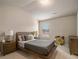 Comfortable bedroom with neutral tones, tray ceiling, and a view of the window at 263 Osier Dr, Mcdonough, GA 30252