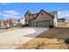 Angle view of a two-story brick home showing the driveway and manicured lawn at 263 Osier Dr, Mcdonough, GA 30252