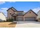 Beautiful two-story brick home with a two-car garage on a sunny day at 263 Osier Dr, Mcdonough, GA 30252