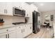 Modern kitchen featuring stainless steel appliances, white cabinetry, and granite countertops at 263 Osier Dr, Mcdonough, GA 30252