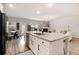 Open-concept kitchen with a large island, stainless steel appliances, and a view of the living area at 263 Osier Dr, Mcdonough, GA 30252