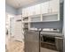 Modern laundry room with storage cabinets, white washer and dryer and stylish decor at 263 Osier Dr, Mcdonough, GA 30252