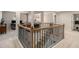 Upstairs landing with a view of an office, staircase with decorative iron railing at 263 Osier Dr, Mcdonough, GA 30252