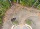 Aerial view of a vacant lot surrounded by trees and new sidewalk in a new community at 4525 Muskogee Ct, Cumming, GA 30040
