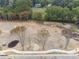 Aerial view of a vacant lot with landscaping ready for construction with trees and rocks at 4525 Muskogee Ct, Cumming, GA 30040
