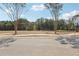 Empty lot in a new construction community with street-ready access and mature trees at 4525 Muskogee Ct, Cumming, GA 30040
