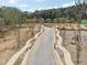 Street view of a new community street with sidewalks, landscaping, and street lights at 4525 Muskogee Ct, Cumming, GA 30040
