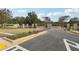 Street view featuring a landscaped entrance to the neighborhood with an American flag and stone pillars at 4525 Muskogee Ct, Cumming, GA 30040