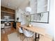 Modern dining area with a light wood table, white chairs, and built-in shelving at 57 Forsyth Nw St # 4H, Atlanta, GA 30303
