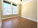 Bright, empty room with hardwood floors, large windows, and city views at 57 Forsyth Nw St # 4H, Atlanta, GA 30303