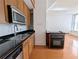 Bright kitchen with wooden cabinets, stainless steel appliances, and a black stovetop at 57 Forsyth Nw St # 4H, Atlanta, GA 30303