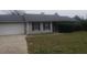 Single-story home with an attached garage, well-kept lawn, and mature landscaping at 10 Oak Wood Ln, Covington, GA 30016