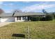 Charming single-story home with an attached garage, a well-kept lawn, and mature landscaping at 10 Oak Wood Ln, Covington, GA 30016