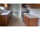 The kitchen features wood cabinets, white counter tops, tile flooring, and stainless steel appliances at 10 Oak Wood Ln, Covington, GA 30016