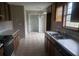 A kitchen with tile floors, wood cabinets, white countertops, and stainless steel double basin sink at 10 Oak Wood Ln, Covington, GA 30016