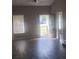 Bright living room featuring a ceiling fan, hardwood-style floors, and a glass paned entry door at 10 Oak Wood Ln, Covington, GA 30016