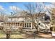 View of the back of the house with large screened porch and windows, surrounded by mature trees at 2833 Landing Way, Marietta, GA 30066
