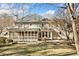 View of the back of the house featuring a screened porch and beautiful green yard with mature trees at 2833 Landing Way, Marietta, GA 30066