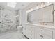 Bathroom featuring dual sinks, glass shower, and a skylight at 2833 Landing Way, Marietta, GA 30066