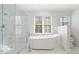 Bright bathroom featuring a soaking tub, glass shower, and large windows at 2833 Landing Way, Marietta, GA 30066
