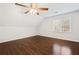 Spacious bedroom featuring dark wood floors, a ceiling fan, and natural light from the window at 2833 Landing Way, Marietta, GA 30066