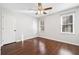 Bright bedroom featuring dark wood floors, a ceiling fan, and natural light from two windows at 2833 Landing Way, Marietta, GA 30066