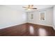 Bright bedroom featuring dark wood floors, ceiling fan, and natural light from two windows at 2833 Landing Way, Marietta, GA 30066