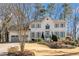 Charming white brick home with well-manicured lawn, mature trees, and a two-car garage at 2833 Landing Way, Marietta, GA 30066