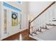 Inviting foyer with hardwood floors, staircase, and decorative glass front door at 2833 Landing Way, Marietta, GA 30066