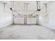 Spacious two car garage with white walls, concrete floor, and two white garage doors with windows at 2833 Landing Way, Marietta, GA 30066