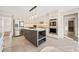 Bright, open kitchen features island with cooktop, stainless appliances, and tiled backsplash at 2833 Landing Way, Marietta, GA 30066