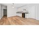 Well-lit kitchenette with white cabinets, dark countertops, mini fridge, and wood floors at 2833 Landing Way, Marietta, GA 30066