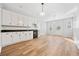 Bright kitchenette featuring white cabinets, dark countertops, a mini fridge, and wood floors at 2833 Landing Way, Marietta, GA 30066