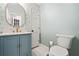 Charming powder room featuring a modern vanity, gold hardware, and stylish wallpaper at 2833 Landing Way, Marietta, GA 30066