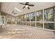 Enclosed sunroom with abundant natural light, multiple ceiling fans, and a lovely backyard view at 2833 Landing Way, Marietta, GA 30066