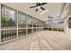 Enclosed sunroom with abundant natural light, multiple ceiling fans, and a charming wooded view at 2833 Landing Way, Marietta, GA 30066
