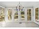 Bright sunroom with tiled floor, multiple windows offering backyard views, and access to patio at 2833 Landing Way, Marietta, GA 30066