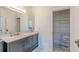 Well-lit bathroom with marble countertop, tiled floor, and closet with shelving at 1763 Mercer Ave, Atlanta, GA 30337