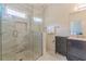 Bathroom with a walk-in shower, tiled walls and floor, and vanity with sink at 1763 Mercer Ave, Atlanta, GA 30337