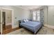 Well-lit bedroom boasts hardwood floors, large window and stylish decor at 1763 Mercer Ave, Atlanta, GA 30337