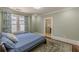 Comfortable bedroom featuring hardwood floors, bright windows and ensuite bathroom at 1763 Mercer Ave, Atlanta, GA 30337