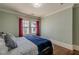 Bedroom featuring hardwood floors and windows with curtains for privacy and elegance at 1763 Mercer Ave, Atlanta, GA 30337