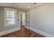 Bright bedroom with wood floors, window, white trim and a door to another room at 1763 Mercer Ave, Atlanta, GA 30337