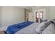 Bedroom with blue bedding, hardwood floors, and white trim, offering a comfortable space at 1763 Mercer Ave, Atlanta, GA 30337