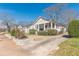 Charming single-story house showcasing a cozy porch and a lush green front yard at 1763 Mercer Ave, Atlanta, GA 30337